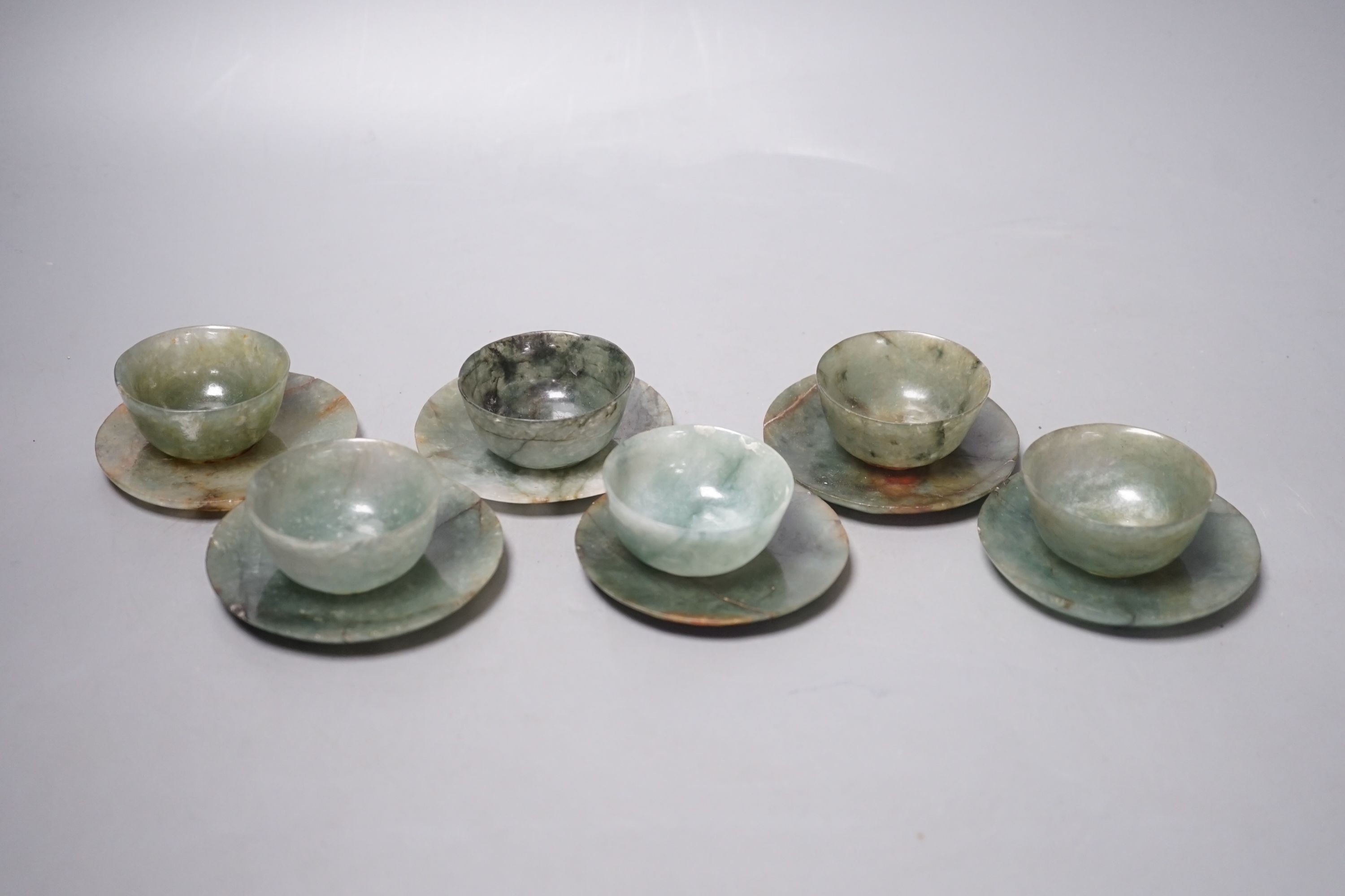 A set of six Chinese moss agate tea bowls and six saucers, engraved Qianlong mark, 19th century, saucers 8cm diameter